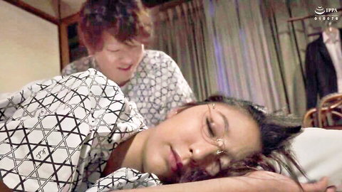 Asian woman in yukata lying relaxed as man caresses her back in JAV scene