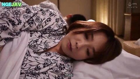 Japanese brunette housewife lying asleep in bed with floral robe draped over her curves