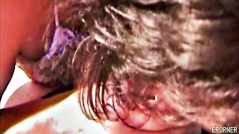 Mature dark-haired woman giving intense blowjob close-up