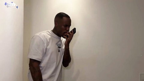 Muscular Black man in white t-shirt on phone, foot fetish sex thumbnail
