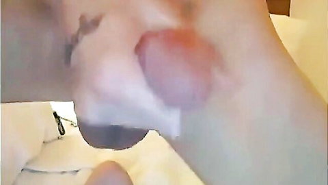 Slender brunette webcammer with tattoo masturbating close-up