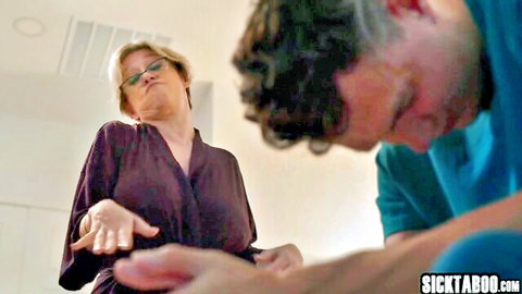 Dee Williams as busty blonde stepmom extending hand to kneeling stepson
