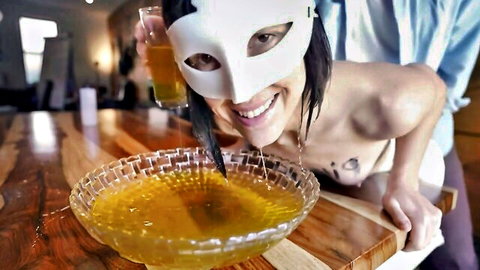 Masked Asian teen topless over golden shower bowl in piss play