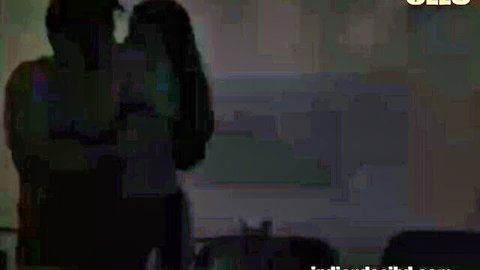 Shadowy couple passionately embracing from behind in dim bedroom OnlyFans tease