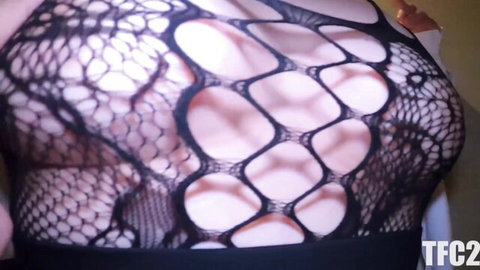Mature Japanese woman in black fishnet bodysuit exposing curves