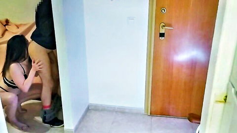 Indian beauty in pink lingerie kneels teasingly in hotel doorway
