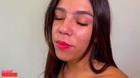 Seductive Brazilian morena with glossy red lips, eyes closed in ecstasy close-up