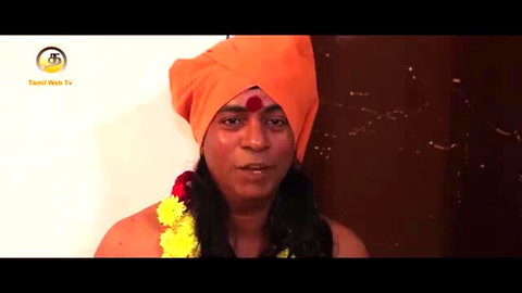 Tamil crossdresser sadhu in orange turban garland bare chest long hair