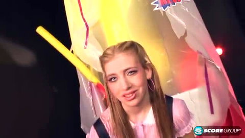 Sara Blonde in sexy pink doll dress with yellow baton, playful pose