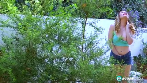 Blonde teen Veronica Valentine teasing in green crop top & shorts outdoors