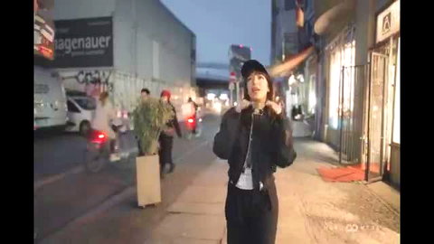 Paulita sexy walk on Berlin street at night in black bomber jacket and cap