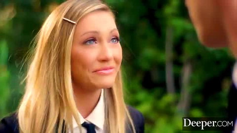 Adira Allure blonde schoolgirl in uniform smiling seductively