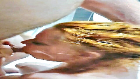 Redhead woman performing intense blowjob on man in wet scene
