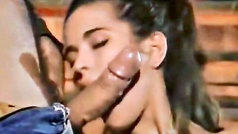 Mature brunette woman rubs her lips and cheek on thick pierced brown cock