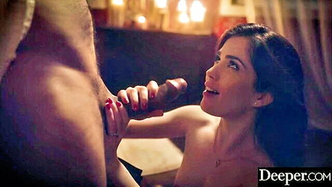 Skinny brunette with small tits smiles naughtily at thick pink dildo gripped by muscular man's hand while nude.