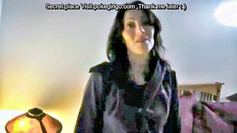 Seductive brunette MILF in dark hoodie teases seductively in bedroom POV