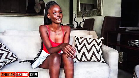 Amateur black model in red top, white mini skirt, long braids, casting couch tease