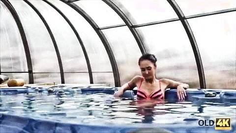 Black-haired Asian beauty in pink bikini relaxes in hot tub - Old4K