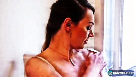 Micky Bells busty brunette in thin straps lingerie, side profile