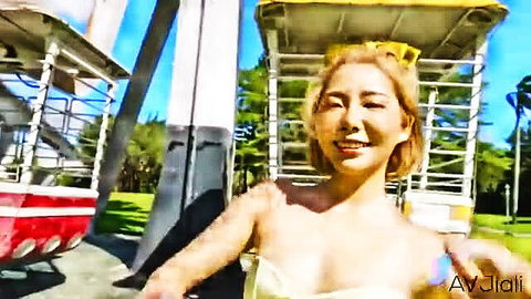 Stacy blonde Asian babe in yellow top smiling at amusement park first date
