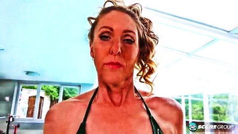 54yo blonde MILF in tiny green bikini showing off curves