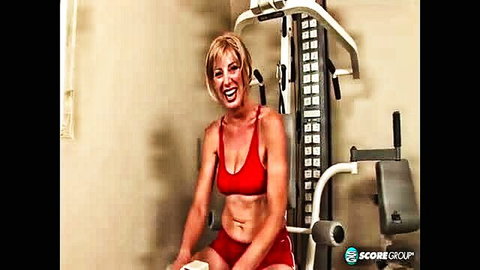 Liz Summers blonde MILF in tight red sports bra on gym machine