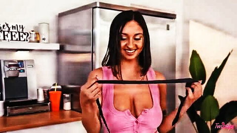 Malisa Moir busty tease in pink top holding black strap, huge cleavage