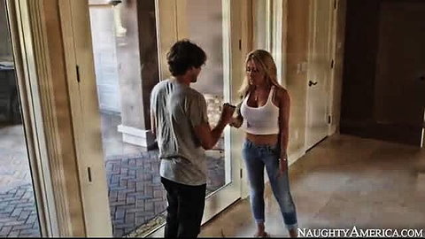 Capri Cavanni in tight white tank top and jeans with guy at home