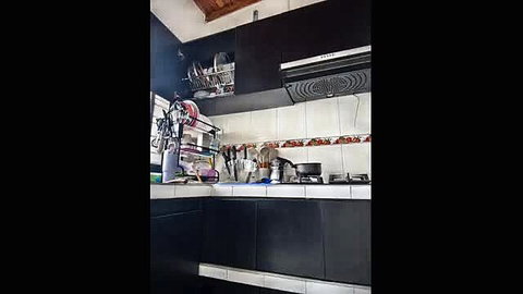 Cozy modern kitchen corner with black cabinets and tiled backsplash