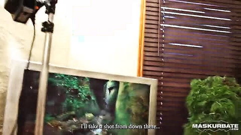Amateur masked woman poses nude by green plants in studio shoot