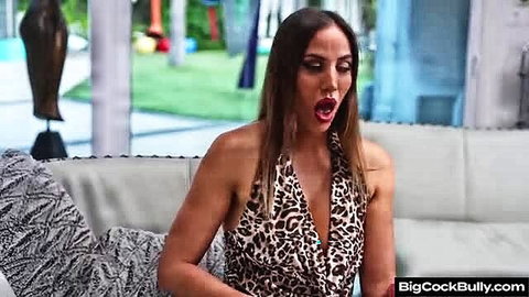 Hot Latina in leopard dress screaming passionately on couch