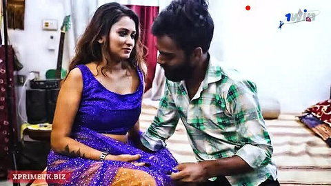 Indian couple in intimate moment, woman in blue saree blouse with man
