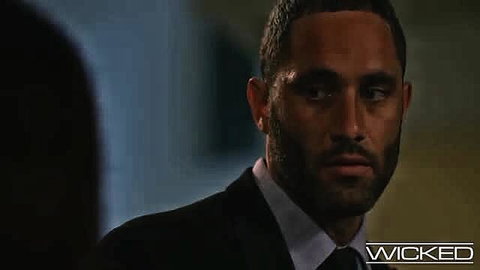 Handsome mixed-race man in suit stares intensely close-up