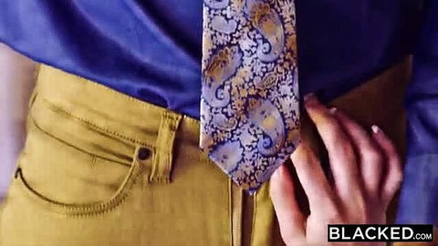Man in blue shirt, yellow pants and paisley tie gropes crotch closeup