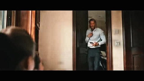 Handsome bearded white man in white shirt and pants at doorway
