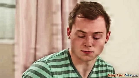 Closeup of young white male in green striped shirt, intense gaze
