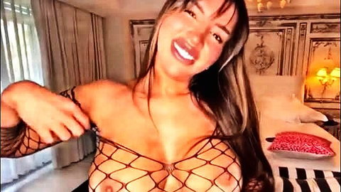 Asian beauty in fishnet lingerie smiling seductively