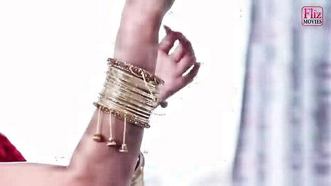 Indian darkhaired babe in gold bangles, erotic arm tease