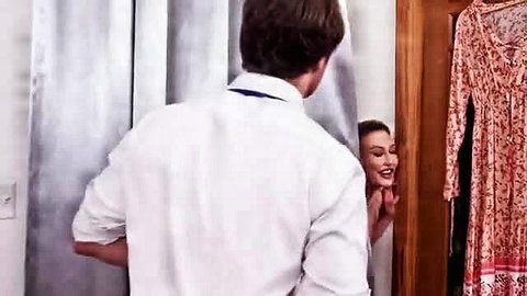 Horny MILF smiling at younger guy in changing room mirror