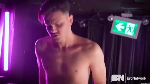 Shirtless DJ hunk in neon club lighting, hot gay stud preview