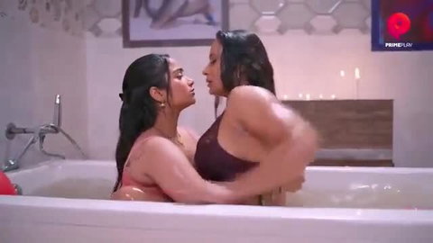 Two busty Indian lesbians kissing passionately in bubble bath