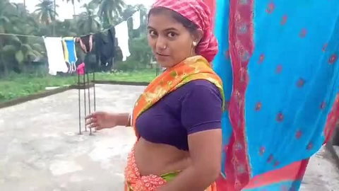 Bunny C busty Indian MILF in orange saree exposing midriff outdoors