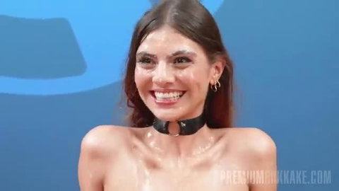 Sulay Pino smiling with choker, nude glistening body at interview