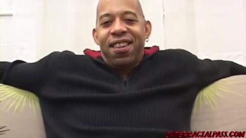 Jennifer Ebony petite MILF smiling in black hoodie on couch