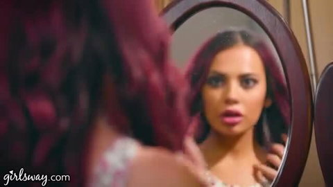 Jillian Janson with pink hair in mirror, hot mean girl stare