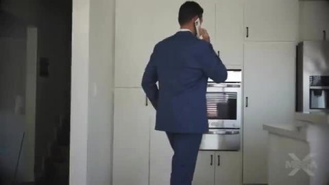 Man in blue suit on phone in kitchen, stepdaughter lap dance tease