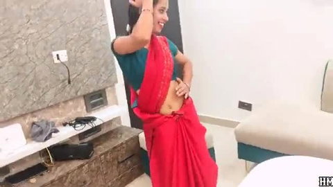 Sexy Indian bhabhi in red saree dances, exposing navel and curves