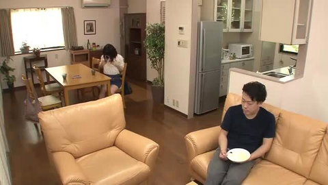 Asian girl in school uniform at table, man with plate on couch