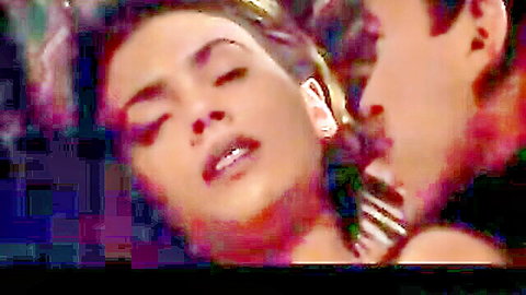 Brunette beauty with ecstatic expression passionately kissed by stud closeup