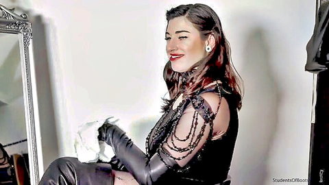 Seductive brunette in sheer beaded top white gloves and leather pants posing teasingly